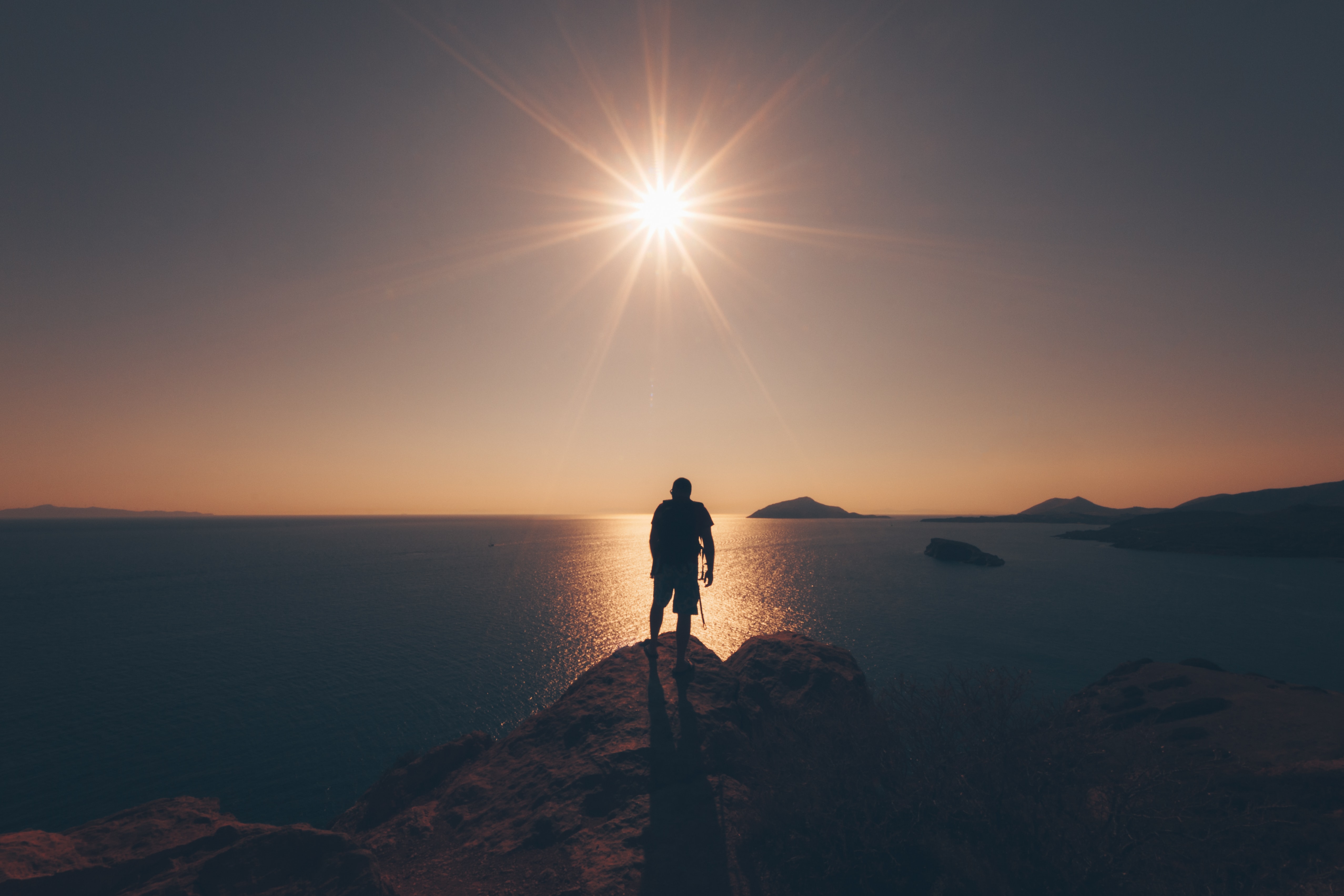 A person on a mountaintop at sunrise